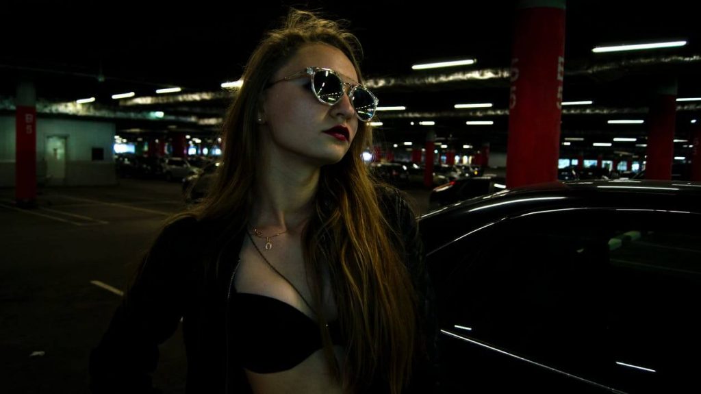 girl-with-sunglasses-by-parking-place